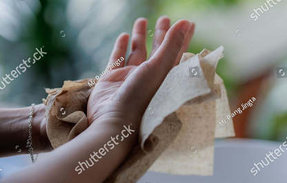 Hands drying with paper towels
